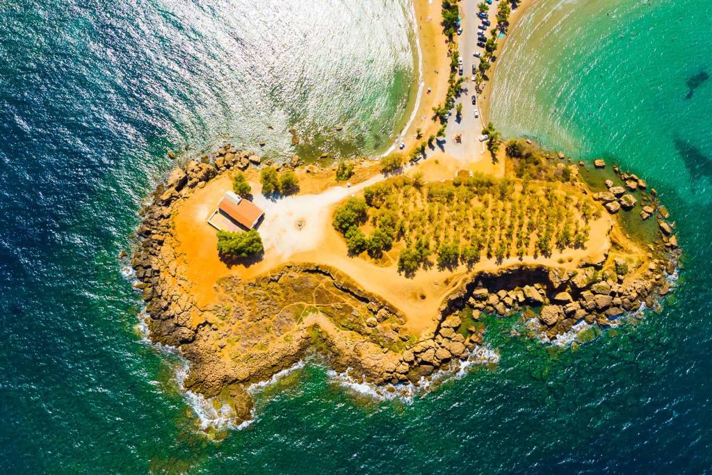 Aerial view of a small chapel in Agii Apostoli Beach.