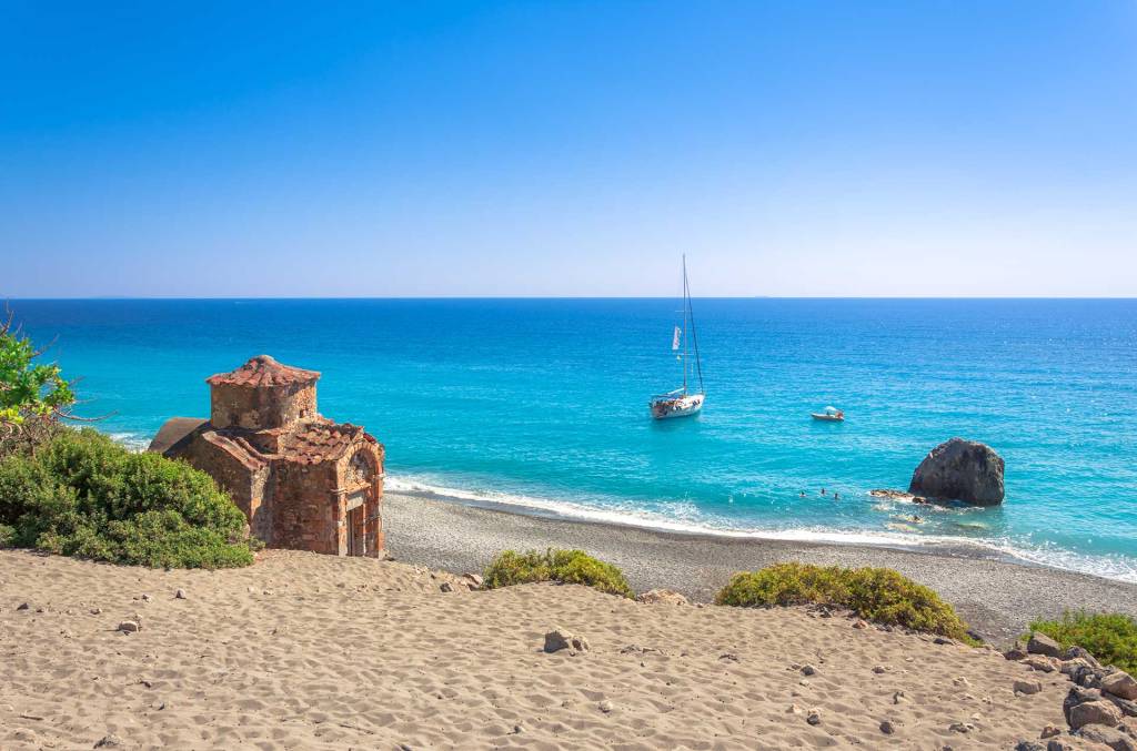 A catamaran in the waters of Agios Pavlos Beach.