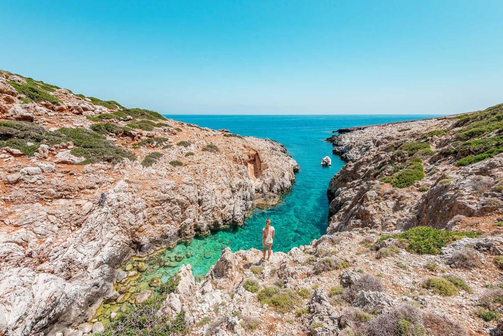 A woman standing and admiring Katholiko Bay in Akrotiri (Chania).