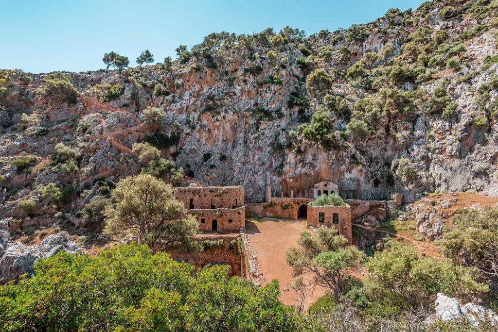 Katholiko Monastery is surrounded by green trees.