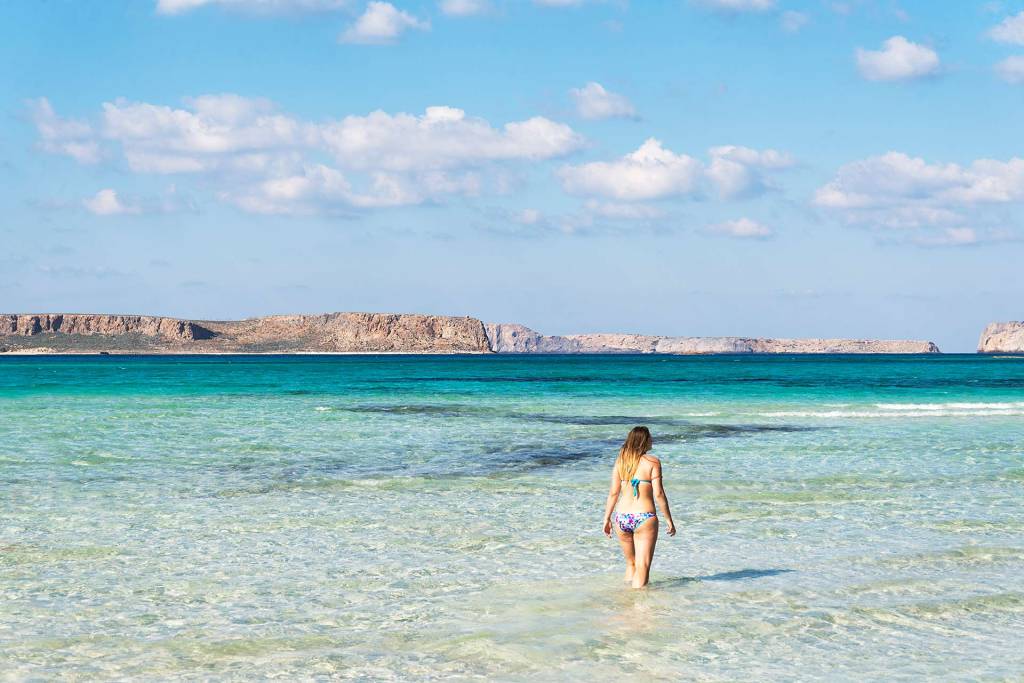 A girl prepares to swim into the waters of Balos Beach.
