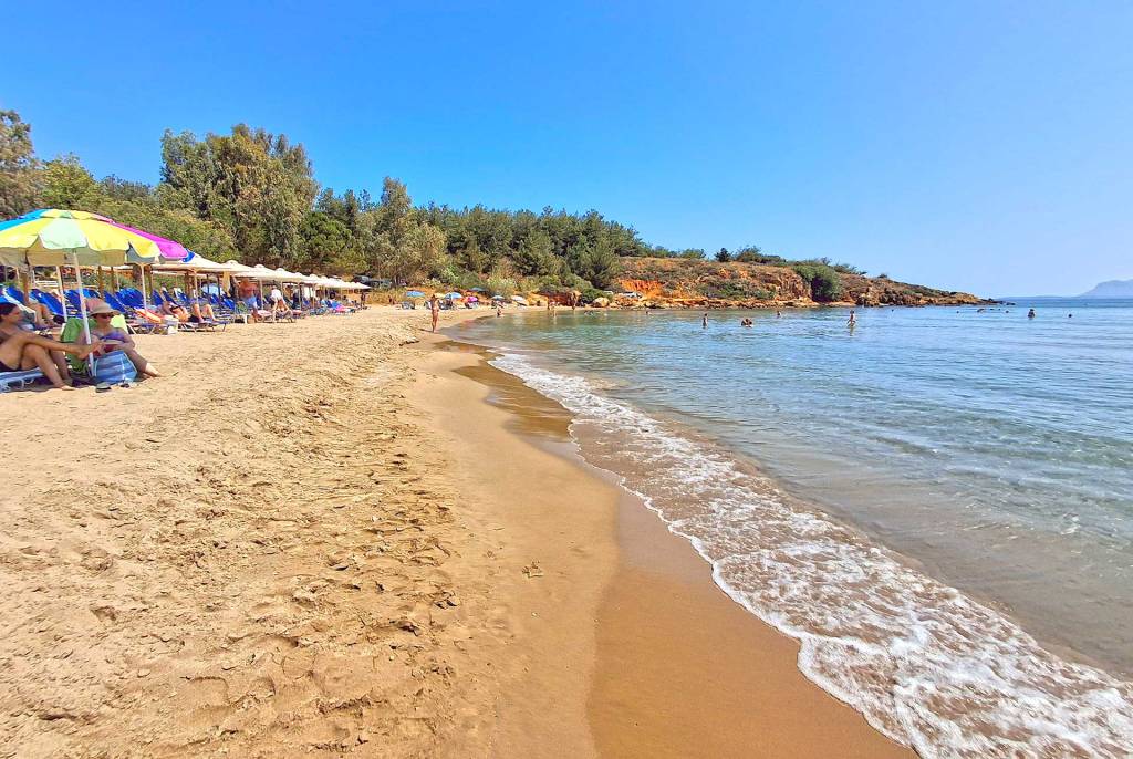 Gentle waves on the sandy coast of the organized and sandy Chrissi Akti Beach.