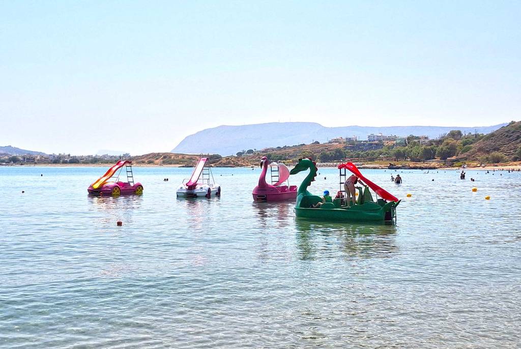 Family waterbikes in the sea of Chrissi Akti Beach, in Chania.