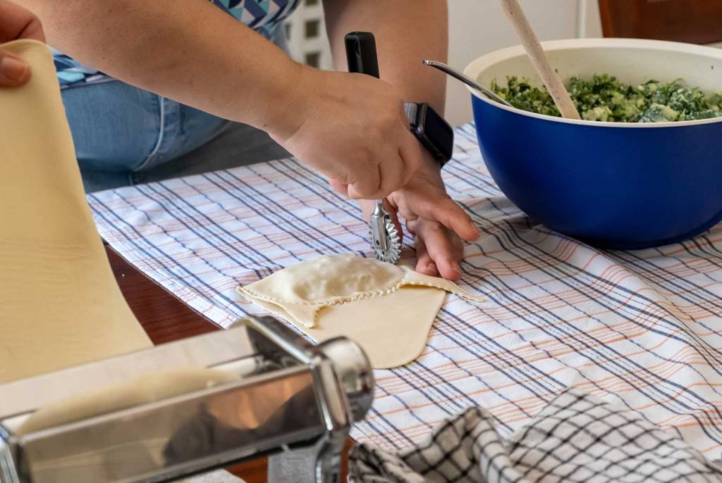 A woman is making dough for kalitsounia.