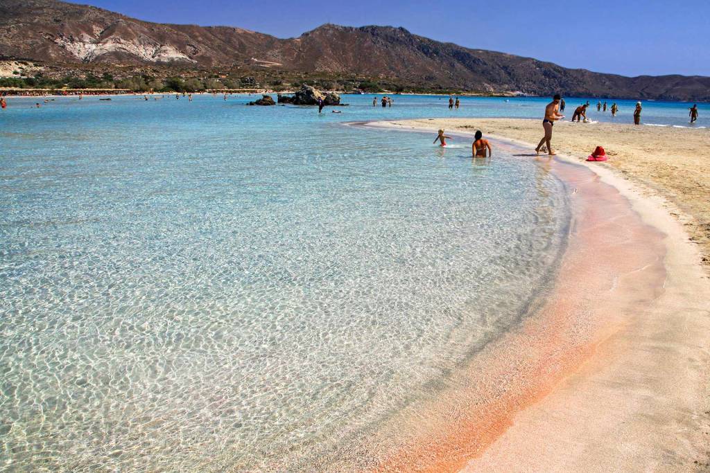 People swim in the waters of Elafonisi Beach.