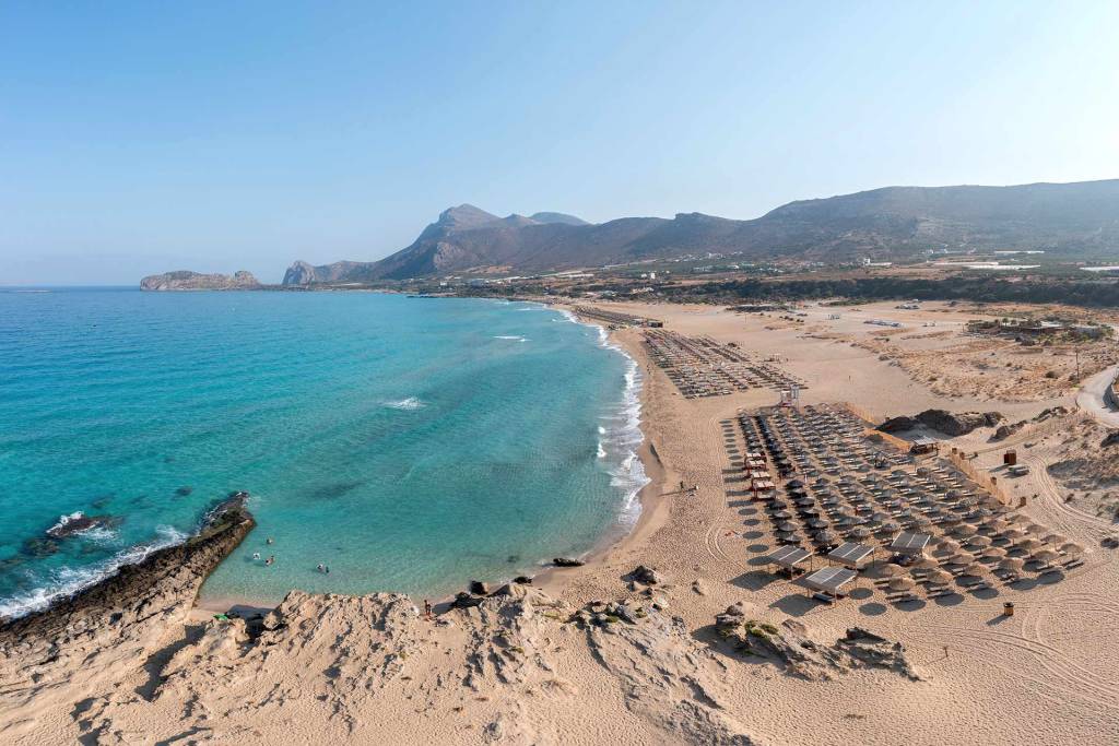 Sunbeds and umbrellas on the long, sandy Falassarna Beach.