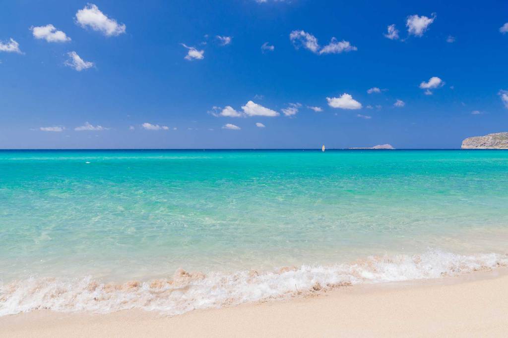 The blue waters and sandy coast of Falassarna Beach.