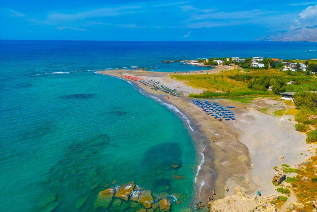 Umbrellas and sunbeds on the sandy beach of Frangokastello.
