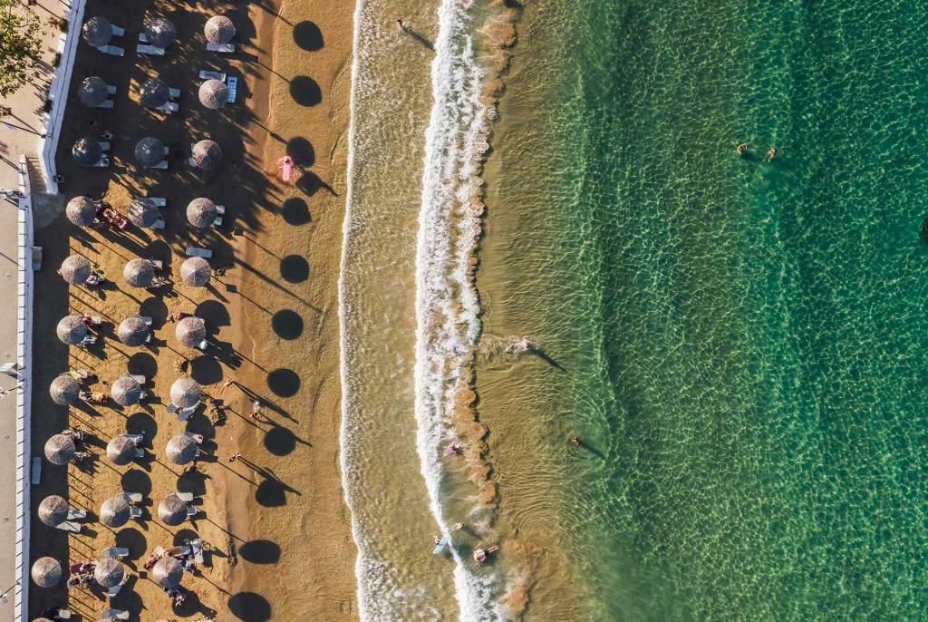 Aerial view of umbrellas and sunbeds in Georgioupolis Beach.