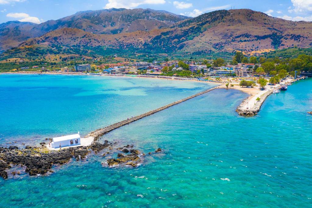View of Agios Nikolaos Church, the beach, and Georgioupolis Village.