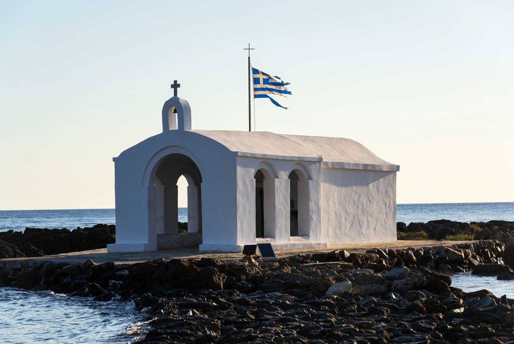 Saint Nicholas Church with the Greek Flag in Georgioupolis.