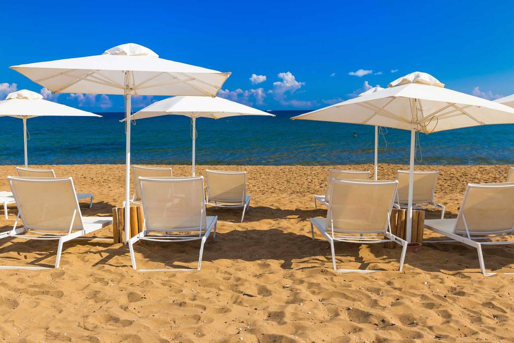 Sunbeds and umbrellas in Kato Stalos Beach.