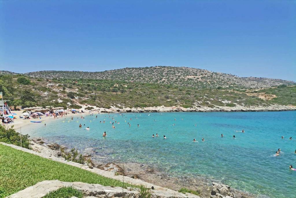 Tourists swimming in the organized beach of Loutraki in Chania.