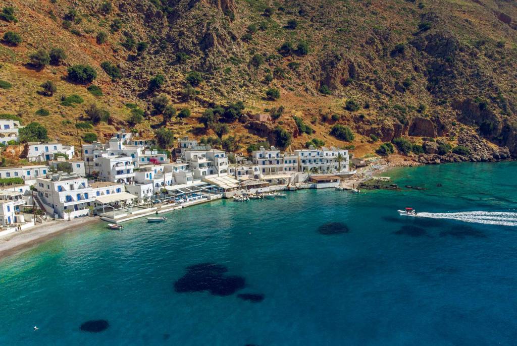 A small boat approaches Loutro Beach.