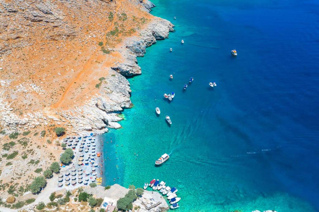 Boats sail to the organized Marmara Beach in South Chania.