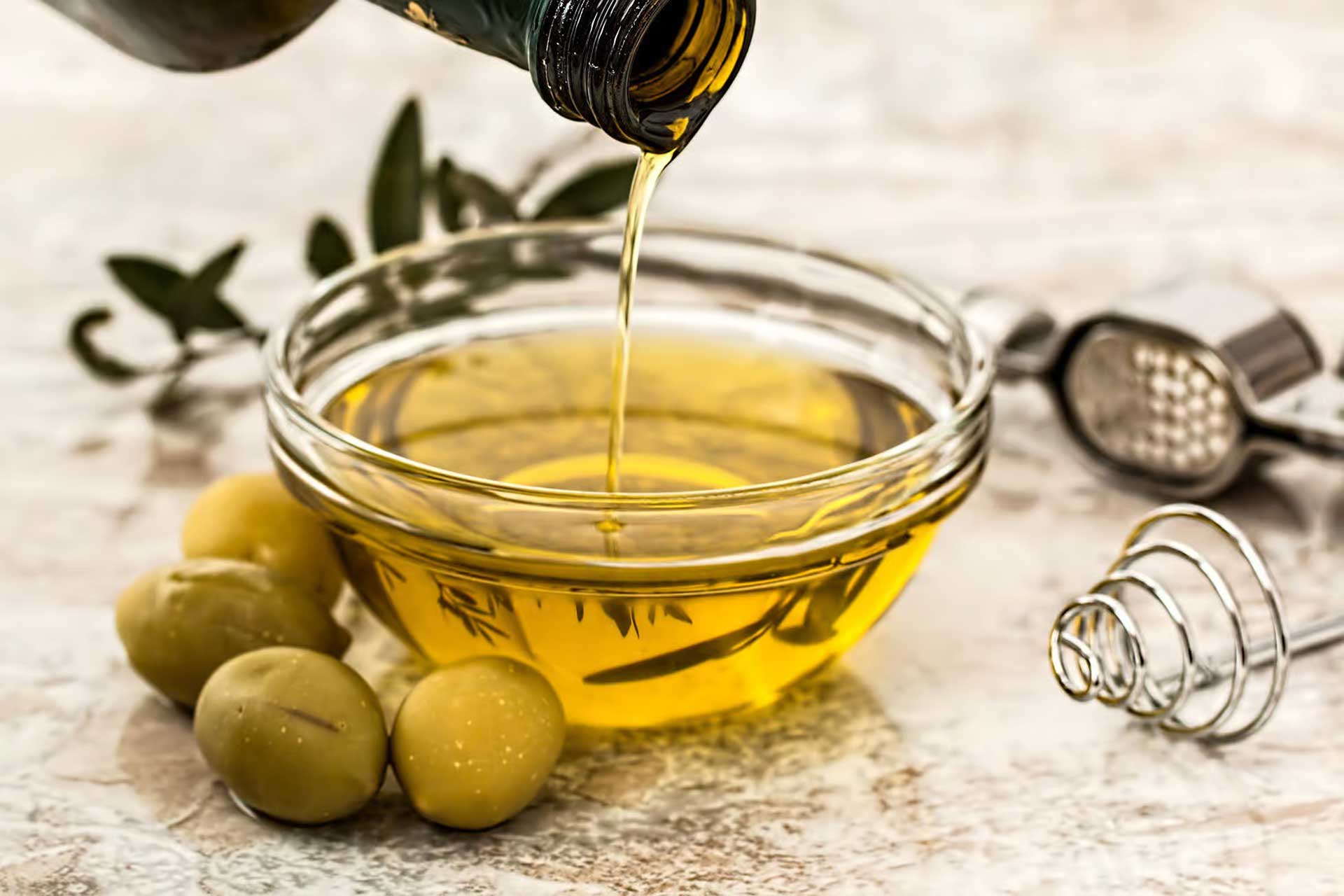 Pouring extra-virgin olive oil onto a plate.