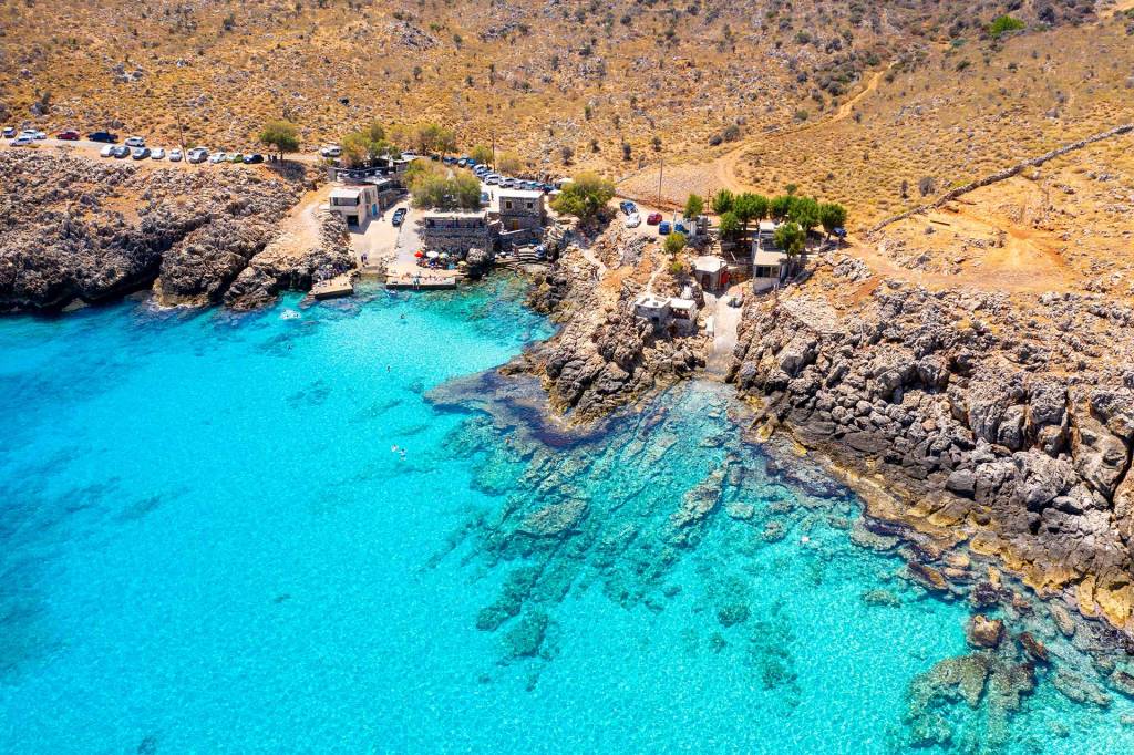 The rocky landscape and turquoise waters of Ombros Gialos Beach.