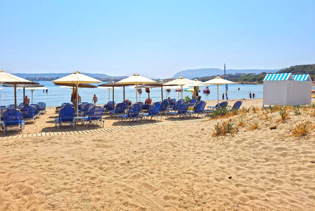 Sand, sunbeds, and umbrellas in Chrissi Akti Beach.