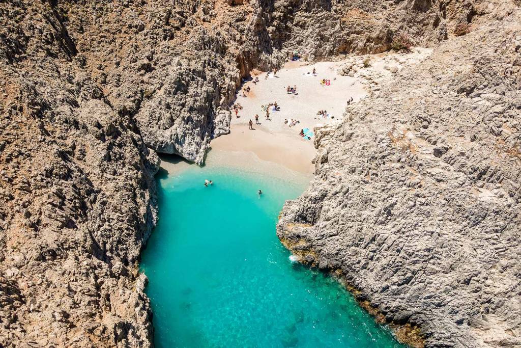 People swimming and sunbathing in Seitan Limania Beach, Chania.