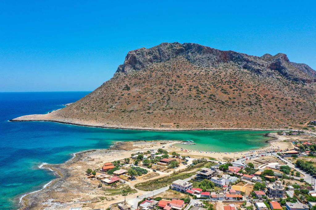 Traditional houses, apartments, the mountain, and Stavros Beach.