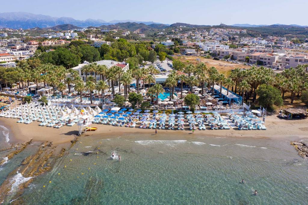 Sunbeds and umbrellas at the organized Agia Marina Beach of Chania.