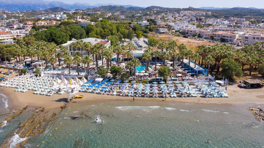 Sunbeds and umbrellas at the organized Agia Marina Beach of Chania.