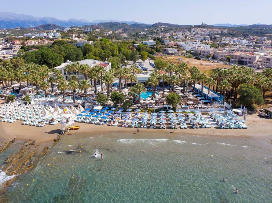Sunbeds and umbrellas at the organized Agia Marina Beach of Chania.
