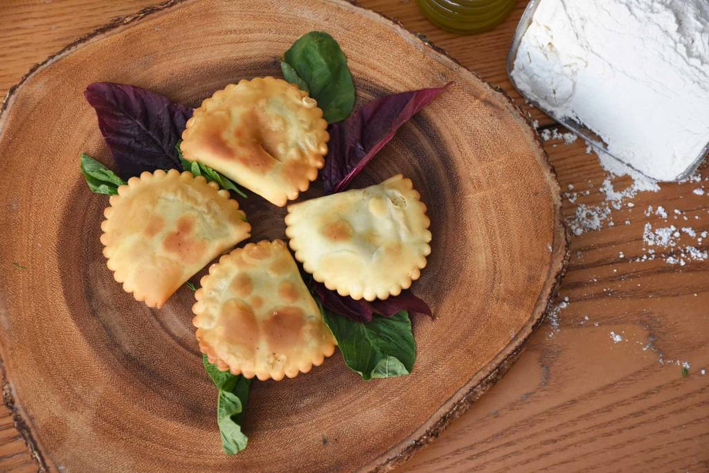 Four fried kalitsounia and some flour.