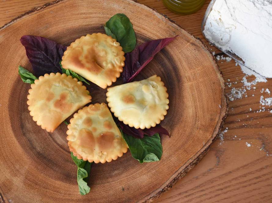 Four fried kalitsounia and some flour.