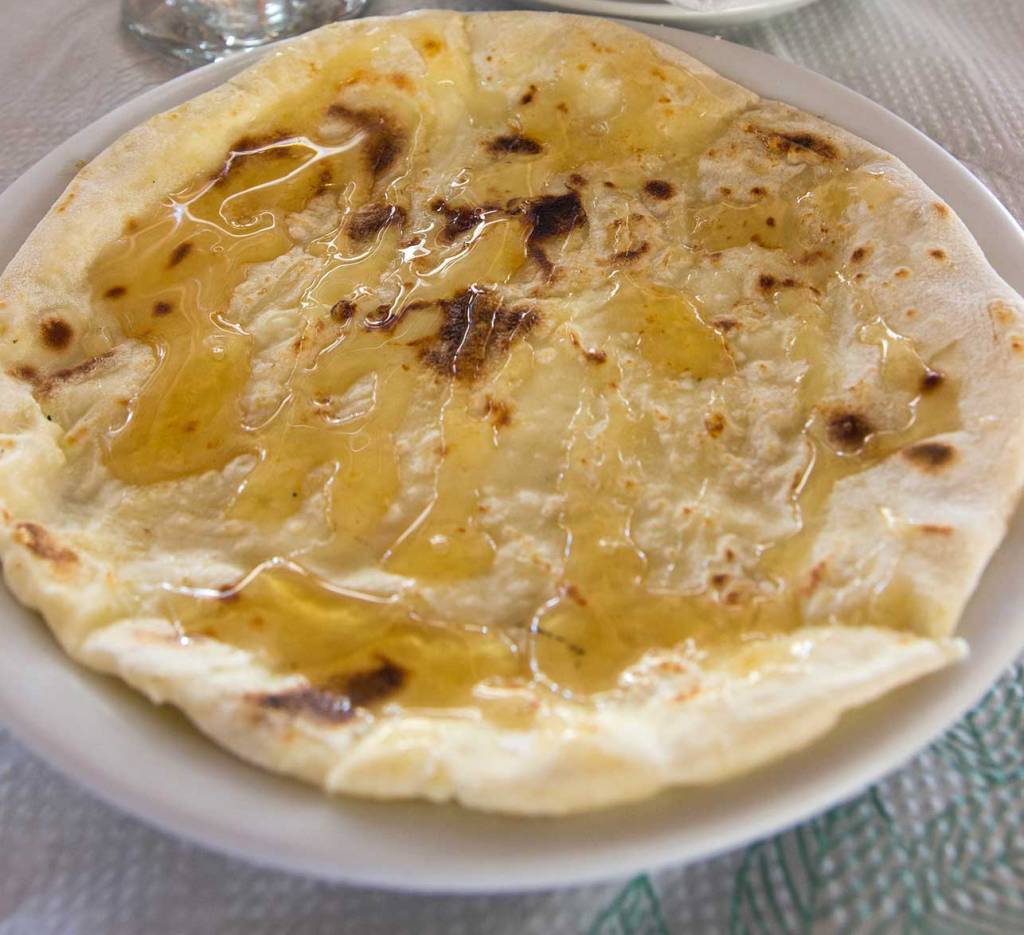 A plate with a Sfakian pie and honey.