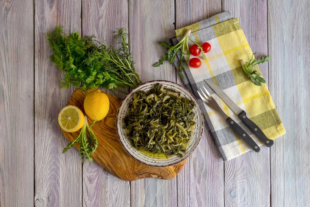 A plate of stamnagathi greens on the table.