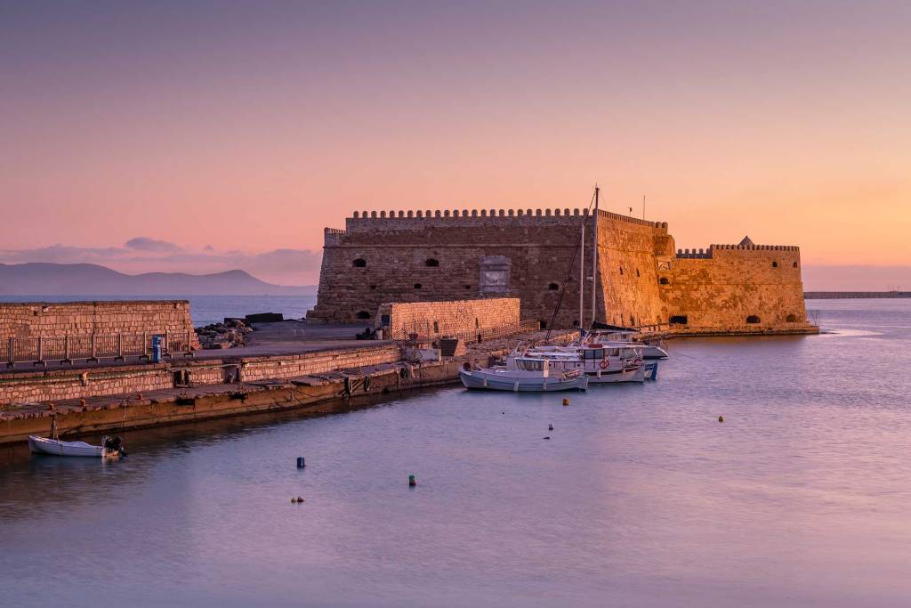 Sunset view of Heraklion Old Venetian Harbor and the fishing boats.