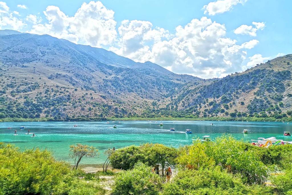 View of Kournas Lake in Chania, the mountains, and the beautiful green trees.