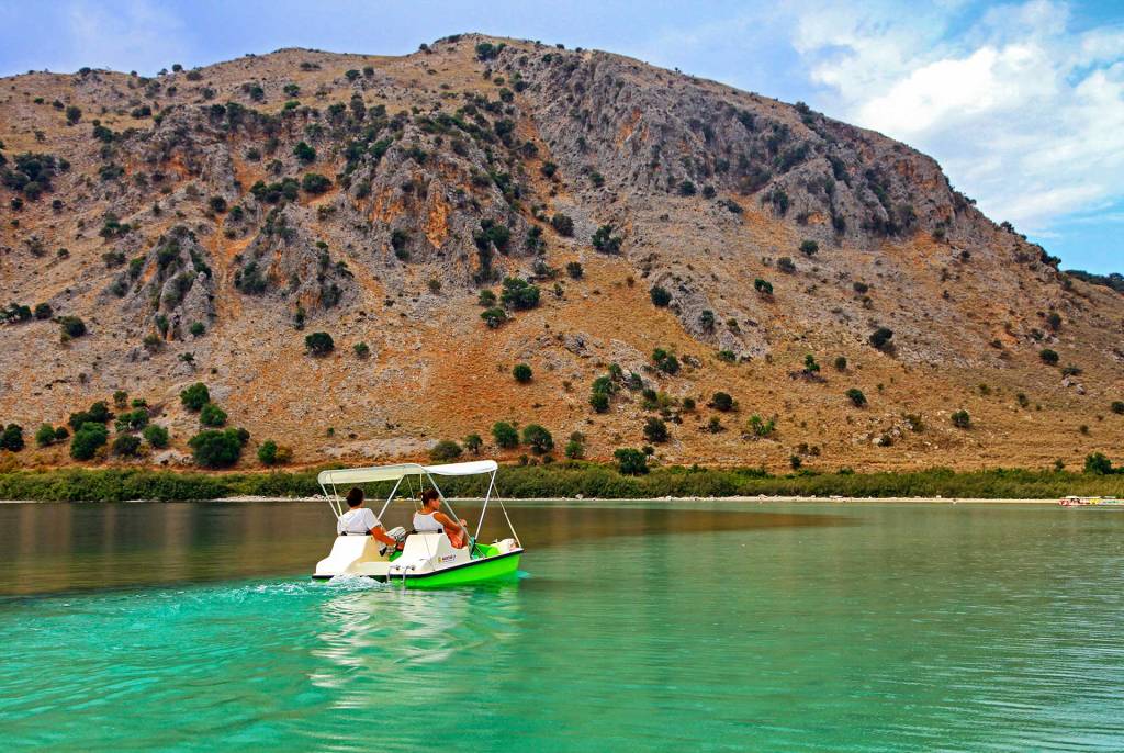 Two tourists enjoy their pedal boat ride in Lake Kournas.