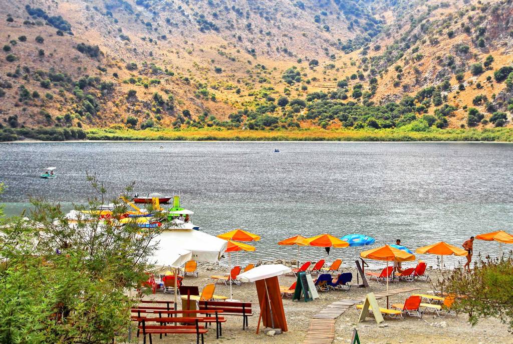 Sunbeds and umbrellas in Lake Kournas.