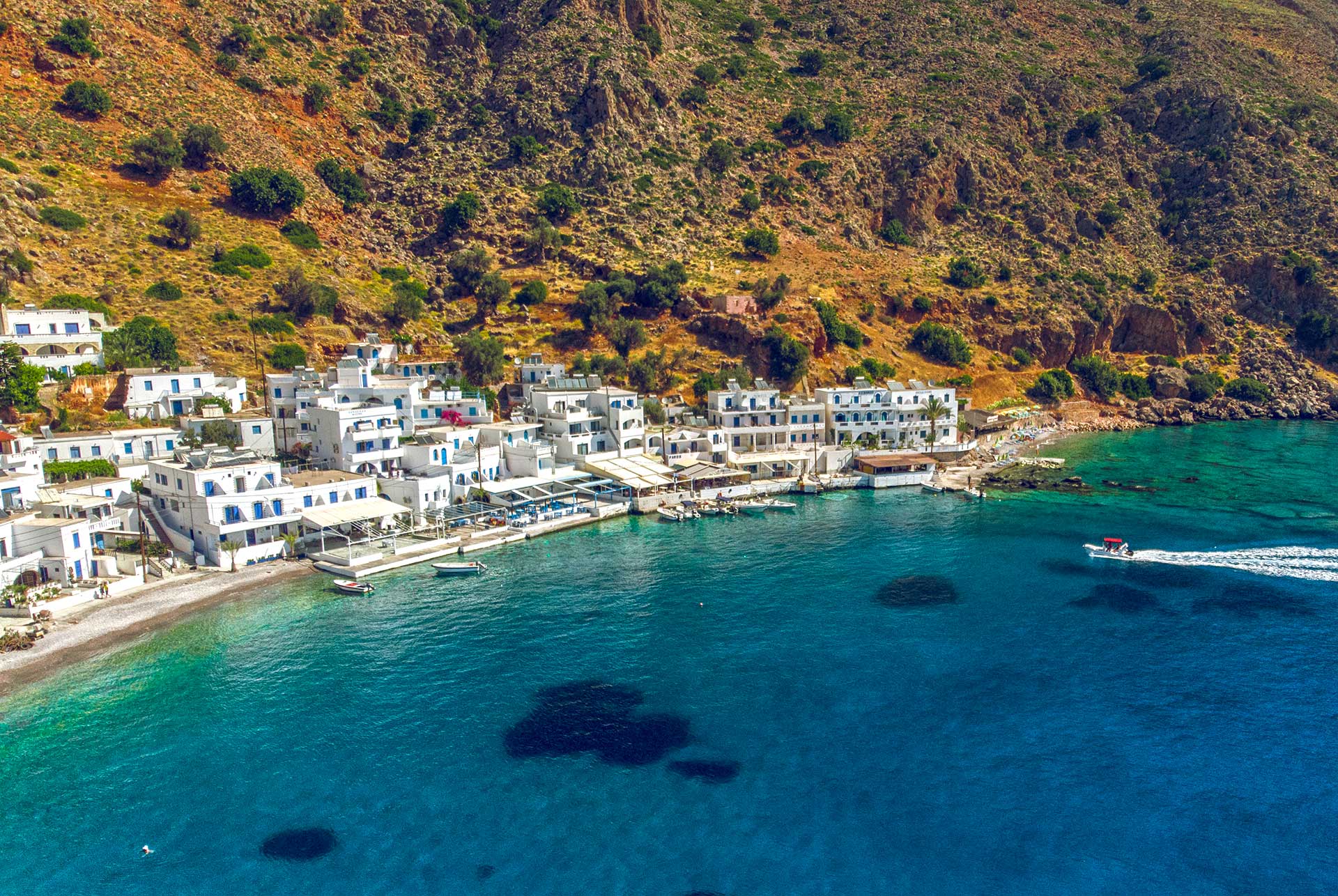 The sea and the picturesque village of Loutro in South Chania, when a boat approaches.