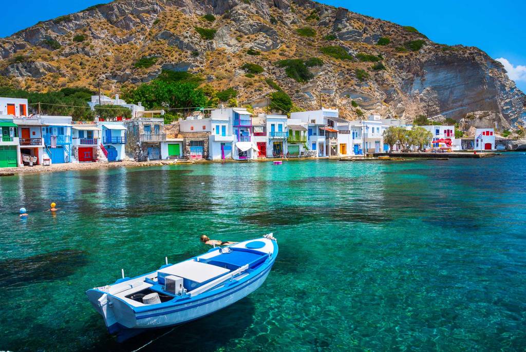 Colorful, picturesque houses and a fishing boat in Klima (Milos).