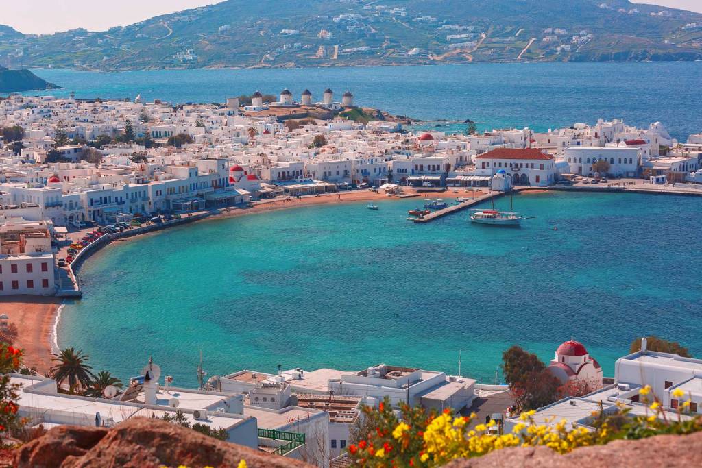 View of the houses, windmills, and the sea in Mykonos Chora.
