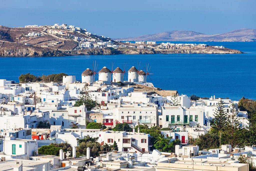 The picturesque Chora of Mykonos with the famous windmills and white buildings.