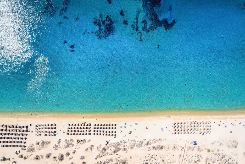 Aerial view of the sandy and organized Agios Prokopios Beach in Naxos.