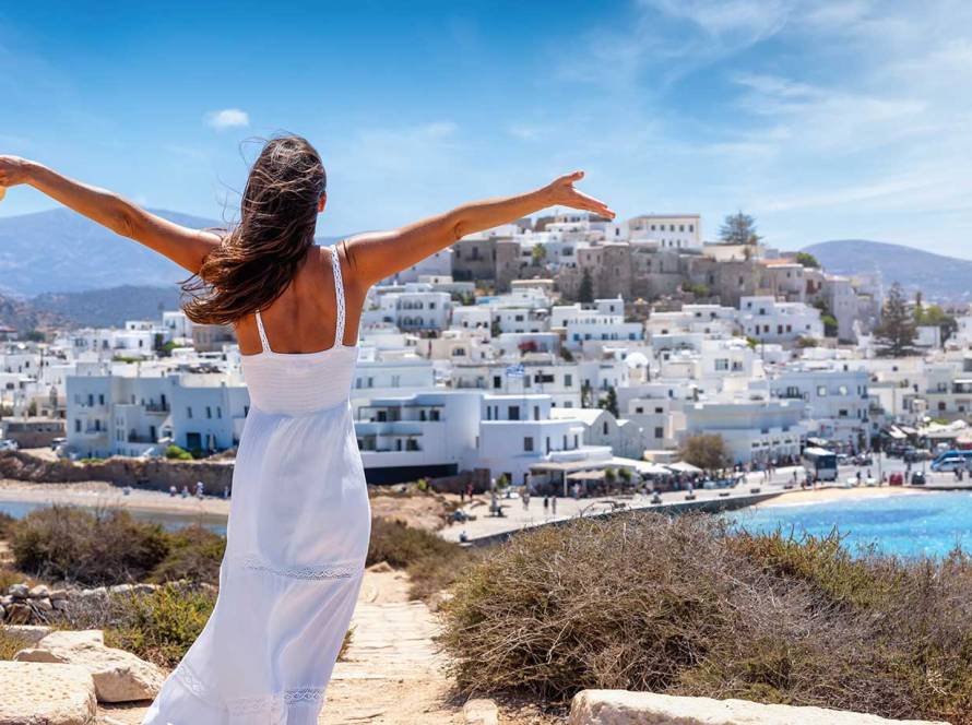 A happy woman enjoys her holidays on Naxos Island.