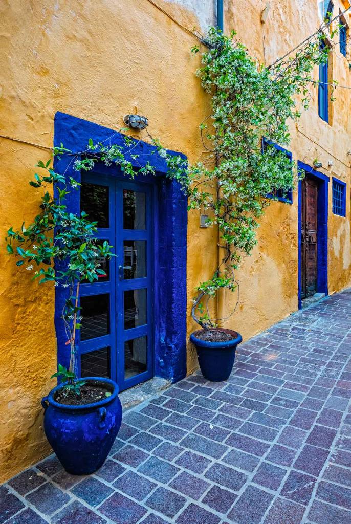 The yellow walls and blue doors of a tavern in Chania Old Town.