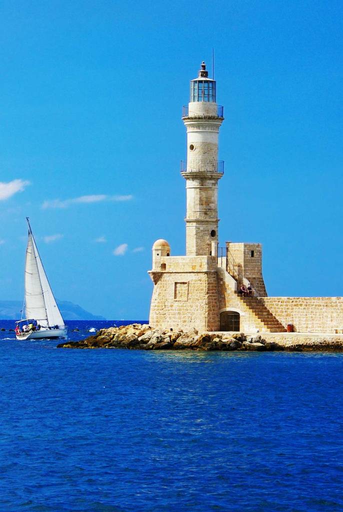 A sailing boat next to the Egyptian Lighthouse of Chania.