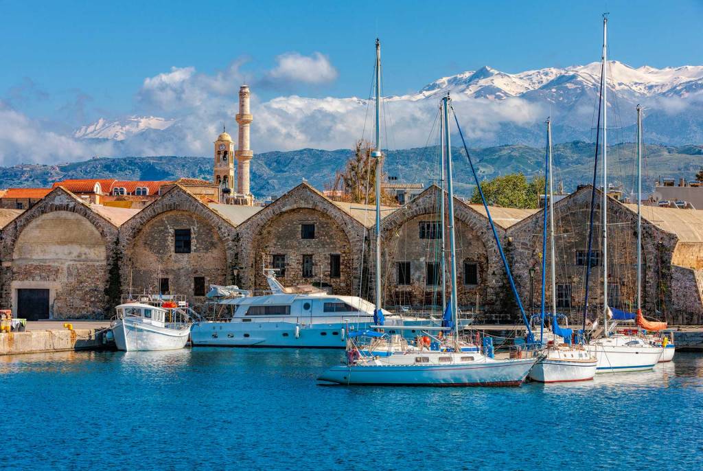 Stone-built Venetian Shipyards and catamarans in the Old Venetian Harbor of Chania.