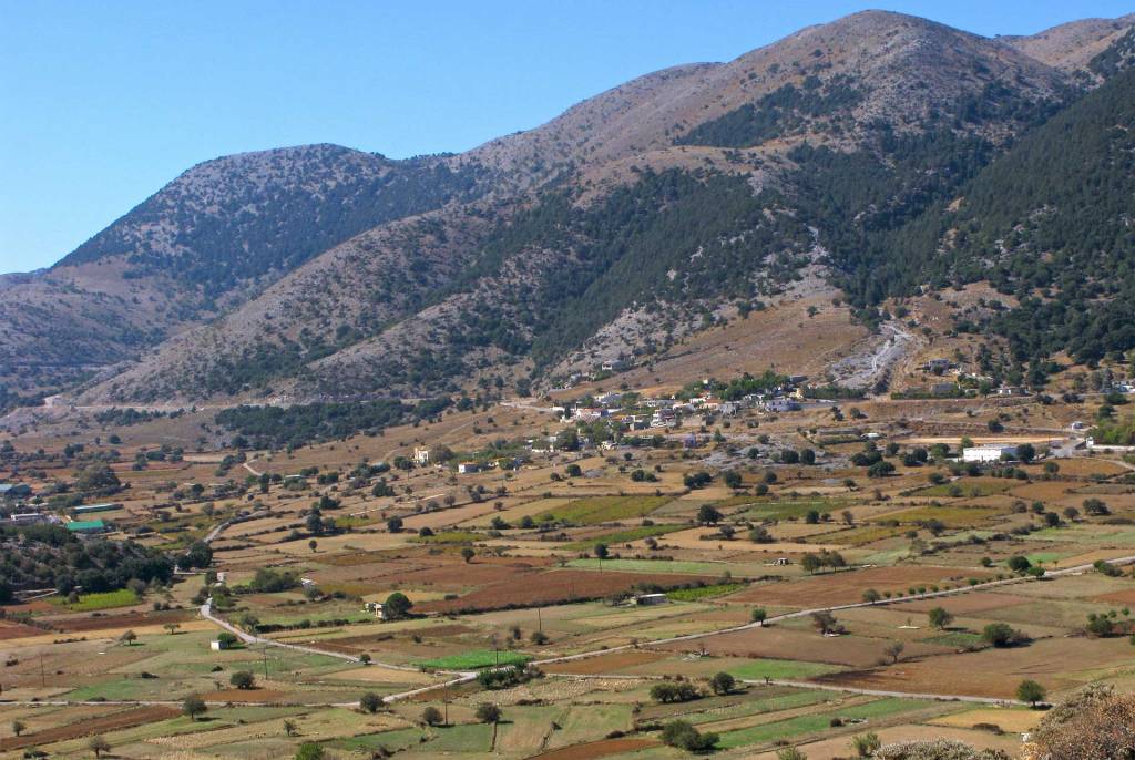 Traditional houses below the mountains in Omalos.