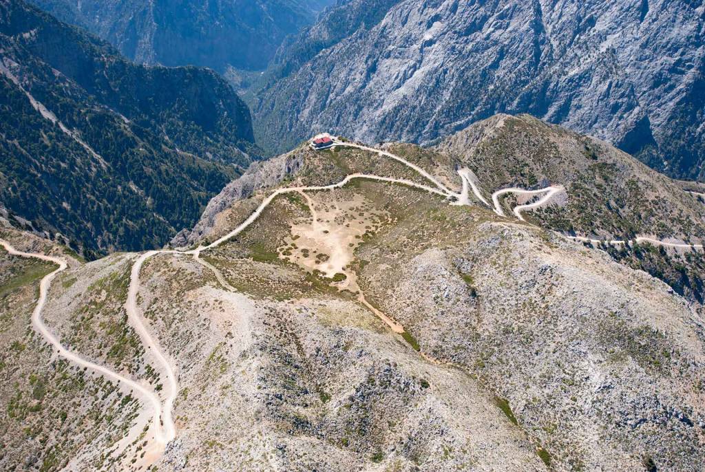 A road leads to a mountain shelter in Omalos.