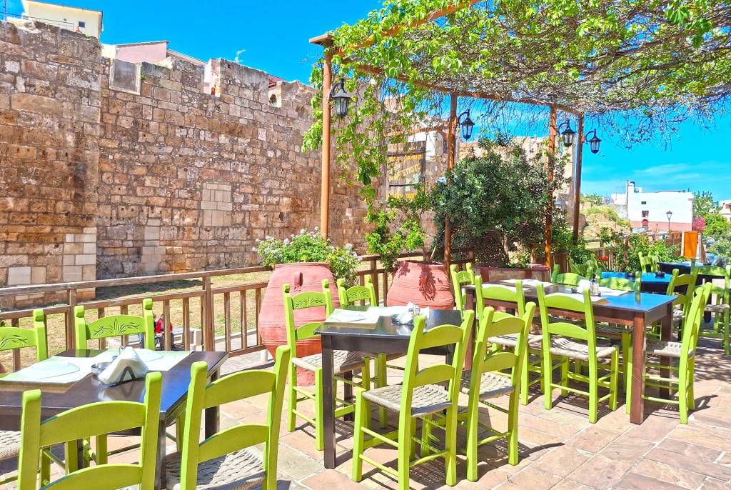 The beautiful small tables of Adespoto Tavern in the heart of the Chania Old Town offering views of the Byzantine Walls.