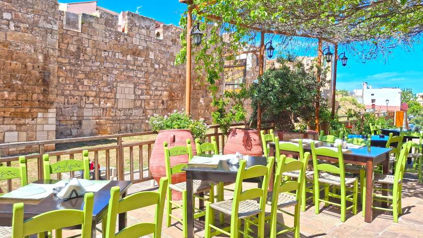 The beautiful small tables of Adespoto Tavern in the heart of the Chania Old Town offering views of the Byzantine Walls.
