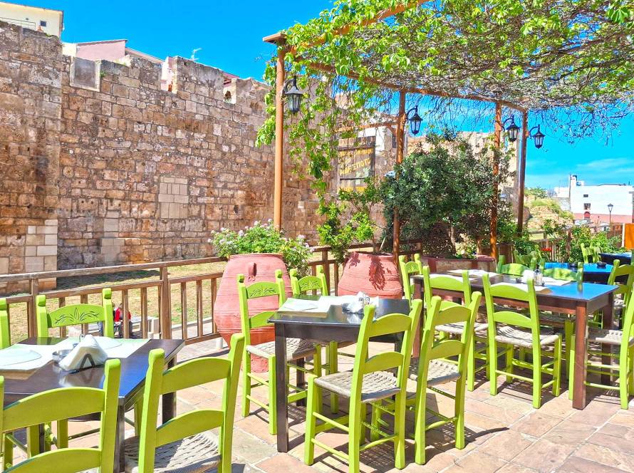 The beautiful small tables of Adespoto Tavern in the heart of the Chania Old Town offering views of the Byzantine Walls.