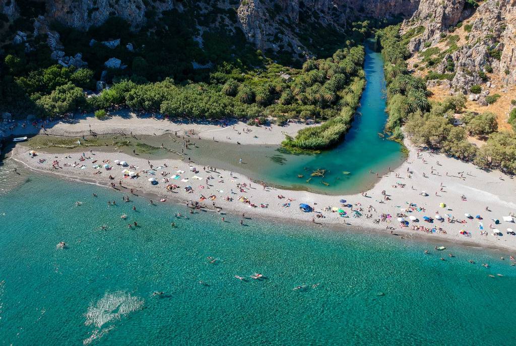 Tourists in Preveli Beach and the Palm Forest of Rethymno.